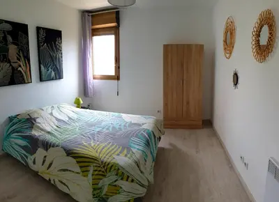 a bedroom with a bed with a colorful blanket at Beau T3 70m2 Ajaccio in Ajaccio