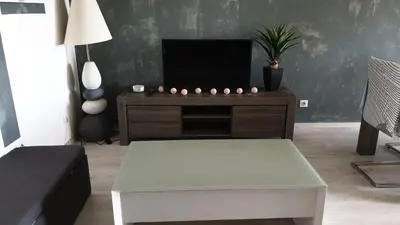 a living room with a tv and a coffee table at Beau T3 70m2 Ajaccio in Ajaccio