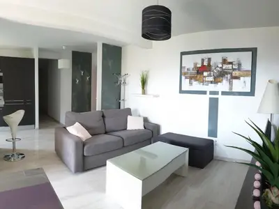 a living room with a couch and a coffee table at Beau T3 70m2 Ajaccio in Ajaccio