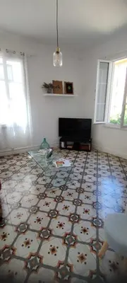 a living room with a patterned floor at Bel F2 près de la plage in Ajaccio