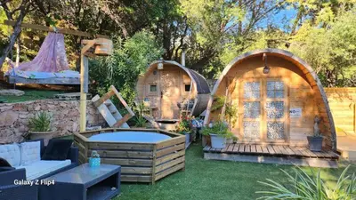 a backyard with two playhouses and a pool at Sunrise T2 avec jacuzzi vue mer in Porto-Vecchio