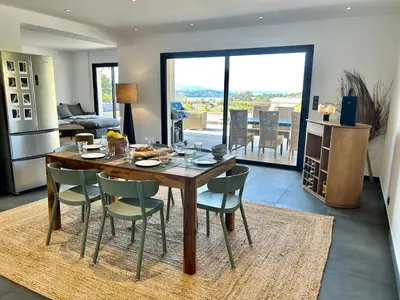a kitchen and dining room with a table and chairs at le Pied à Terre 2 PORTICCIO in Porticcio