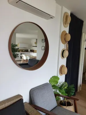 a living room with a mirror on the wall at Villa ARIA et MAQUIS, Villa 4 chambres- Piscine - Plage à pied - vue mer in Pietrosella