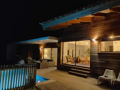 a house with a pool and a patio at night at Villa ARIA et MAQUIS, Villa 4 chambres- Piscine - Plage à pied - vue mer in Pietrosella