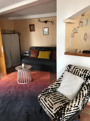 a living room with a couch and a table at Studio de 39 m2 in Vezzani