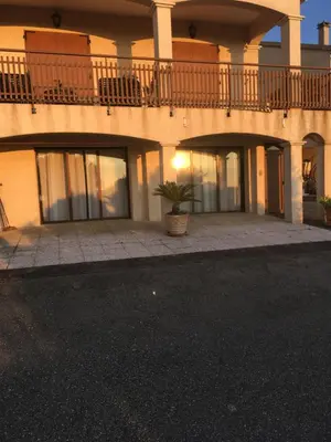 a building with a balcony and a potted plant at Studio de 39 m2 in Vezzani