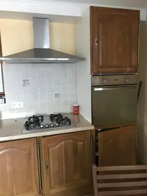a kitchen with a stove and a refrigerator at Studio de 39 m2 in Vezzani
