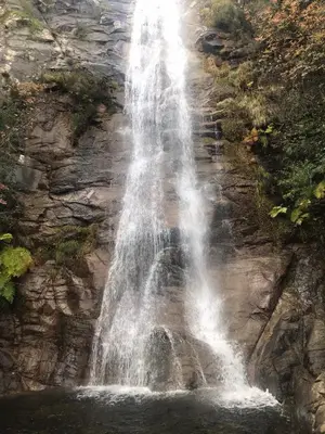 a waterfall on the side of a mountain at Magnifique villa récente entre mer et montagne située entre Ajaccio et Porticcio in Cauro