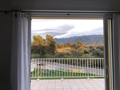 a window with a view of a road and mountains at Superbe Appartement Vue Montagne Proximités Grandes Surfaces in Poggi