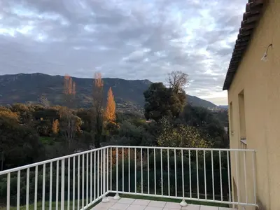 a balcony with a view of the mountains at Superbe Appartement Vue Montagne Proximités Grandes Surfaces in Poggi