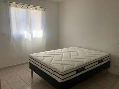 a mattress sitting in a room with a window at Superbe Appartement Vue Montagne Proximités Grandes Surfaces in Poggi