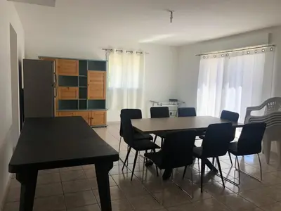 a dining room with a table and chairs at Superbe Appartement Vue Montagne Proximités Grandes Surfaces in Poggi