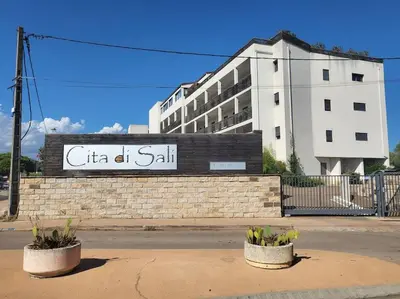 a building with a sign that reads citi at san at Appartement de standing avec piscine et terrasse in Porto-Vecchio