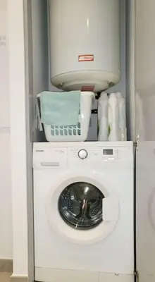 a washer and dryer in a room at Appartement de standing avec piscine et terrasse in Porto-Vecchio