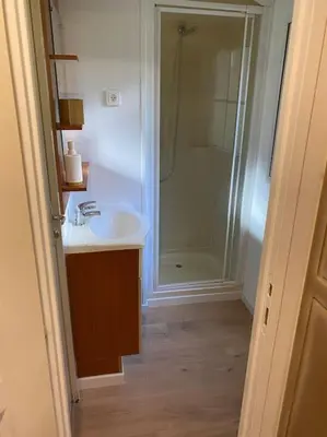 a bathroom with a white sink and a shower at Mobilhome à la campagne in Porto-Vecchio