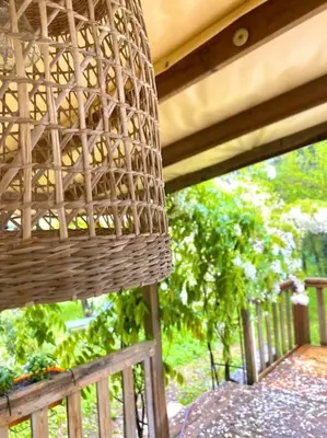 a wicker basket sitting on top of a porch at Mobilhome à la campagne in Porto-Vecchio