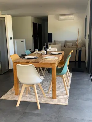 a wooden table with chairs and a dining room at Appartement - Maison 