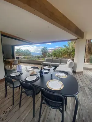 a dining room with a table and chairs and a couch at Appartement - Maison 