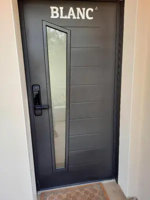 a black door with a mirror and a sign on it at Domaine de Pacciolello - Porticcio in Porticcio
