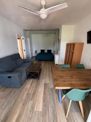 a living room with a couch and a bed at Résidence Punta paliagi in Calcatoggio