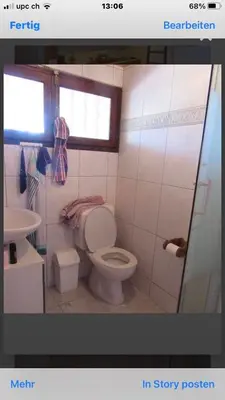 a bathroom with a toilet and a sink at Maison Le Guetali in Sainte-Lucie de Porto-Vecchio