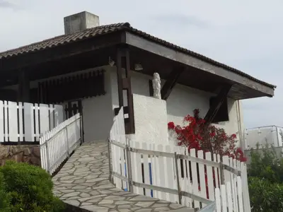 a white fence in front of a house at Maison Le Guetali in Sainte-Lucie de Porto-Vecchio