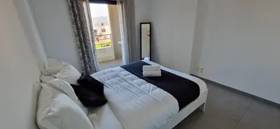 a bedroom with a bed with a box on it at T2 Fronte Di Mare de standing en bord de mer et du centre du village de Propriano in Propriano