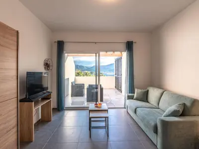 a living room with a couch and a tv at Studio Studio Côté Sud 29 by Interhome in Porto-Vecchio