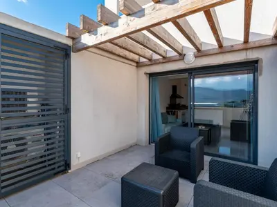 a living room with a view of the ocean at Studio Studio Côté Sud 29 by Interhome in Porto-Vecchio