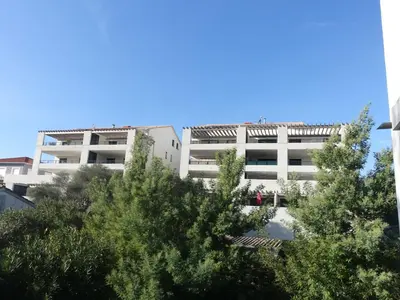 an apartment building with trees in front of it at Studio Studio Côté Sud 29 by Interhome in Porto-Vecchio
