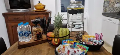 a wooden table with snacks and water bottles on it at Bel & ancien appartement T3 rénové dans Sartène in Sartène