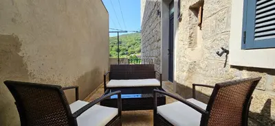 a couple of chairs sitting on a balcony at Bel & ancien appartement T3 rénové dans Sartène in Sartène