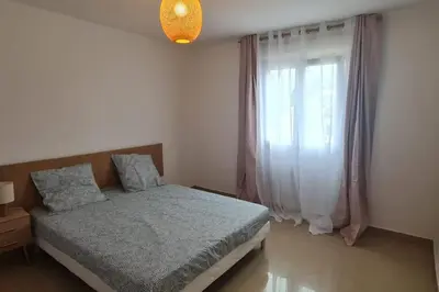 a bedroom with a bed and a window at Magnifique villa avec piscine en bord de Mer in Lucciana