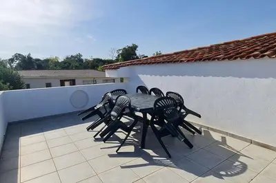 a table and chairs sitting on a patio at Magnifique villa avec piscine en bord de Mer in Lucciana