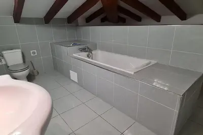 a bathroom with a bath tub and a toilet at Magnifique villa avec piscine en bord de Mer in Lucciana