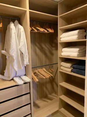 a walk in closet with white clothes and towels at Villa Falcone marinu ***** in Kamiesch