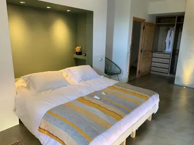 a bedroom with a large bed and a closet at Villa Falcone marinu ***** in Kamiesch