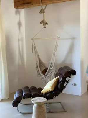 a hammock hanging from a wall in a room at Villa Falcone marinu ***** in Kamiesch