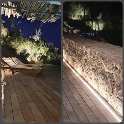 a deck with a bench and a stone wall at Villa Falcone marinu ***** in Kamiesch
