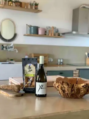 a bottle of wine sitting on a counter in a kitchen at Villa Falcone marinu ***** in Kamiesch