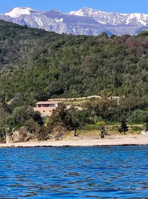 a large body of water with mountains in the background at Villa Falcone marinu ***** in Kamiesch