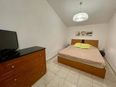 a bedroom with a bed and a flat screen tv at Casa in Cervione