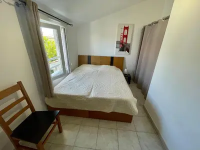 a small bedroom with a bed and a window at Casa in Cervione