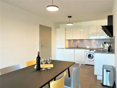 a kitchen with a table with wine glasses on it at BEL' ORIZONTE proche centre ville et plage in Propriano