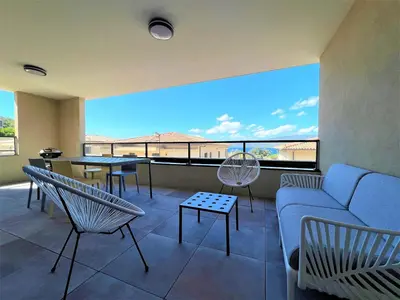 a living room with a couch and chairs and a large window at BEL' ORIZONTE proche centre ville et plage in Propriano