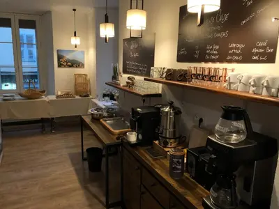 a kitchen with a counter with a coffee maker on it at Hôtel du Nord in Corte