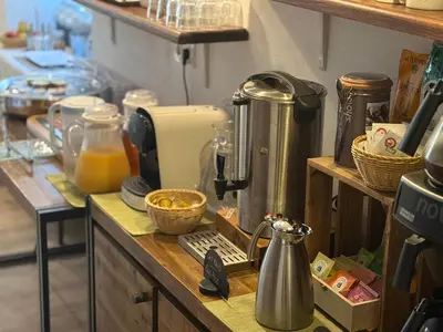 a kitchen counter with a coffee maker and a mixer at Hôtel du Nord in Corte