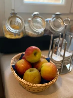 a basket of apples and pears on a table at Hôtel du Nord in Corte