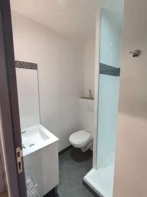a white bathroom with a toilet and a sink at Studio de 25m2 - Extra centre - À 5 min à pied des plages - Commerces et restaurants sur place - Clim - Wifi - EXCEPTIONNEL in Ajaccio