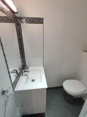 a white bathroom with a toilet and a sink at Studio de 25m2 - Extra centre - À 5 min à pied des plages - Commerces et restaurants sur place - Clim - Wifi - EXCEPTIONNEL in Ajaccio